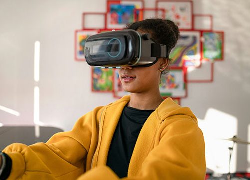 A young woman stood in a living room with a VR headset on and her arms outstretched.