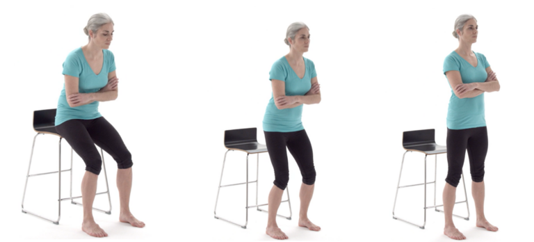 A person with gray hair, wearing a teal shirt and black pants, demonstrates a sit-to-stand exercise by rising from a chair in three sequential stages. The background is plain white.
