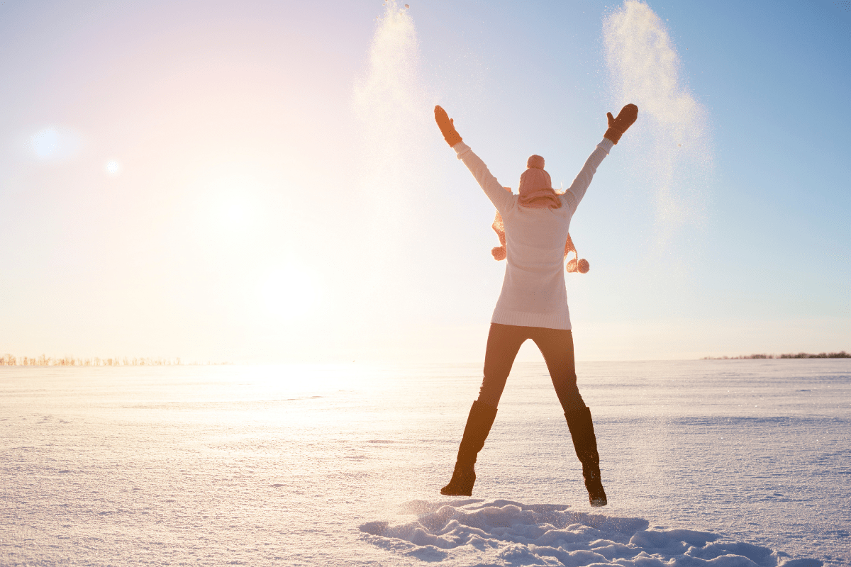 person jumping on snow