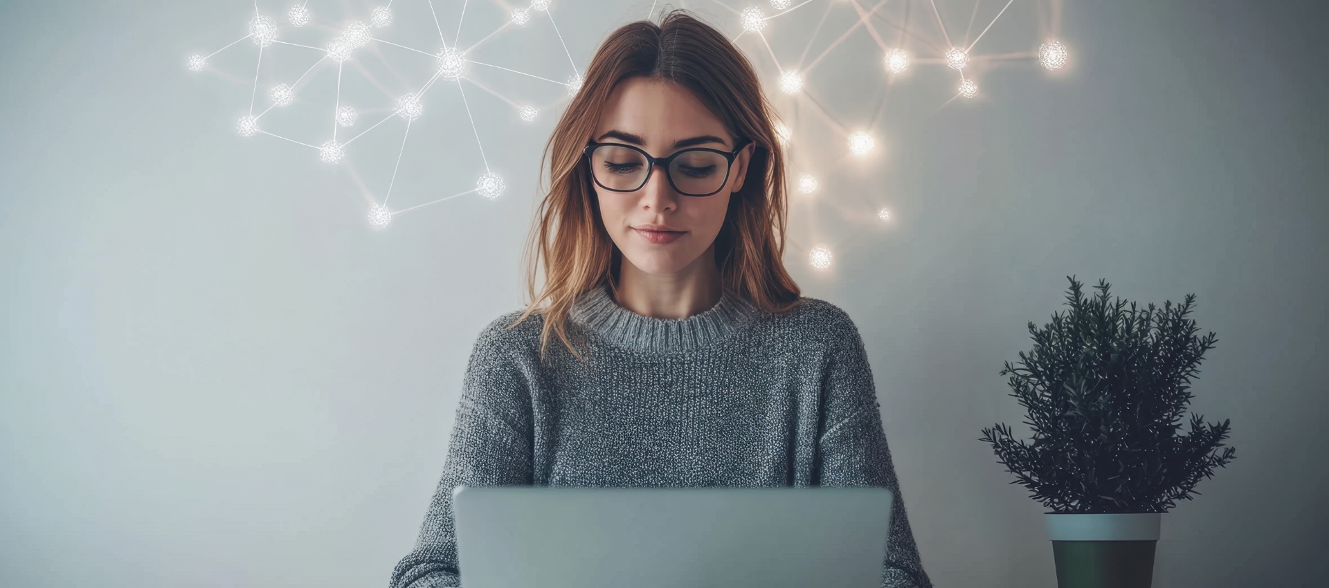 A person sitting at a laptop in a calm, softly lit room, with warm ambient lights on the wall and a small potted plant nearby, suggesting a relaxed setting for an online wellness webinar.